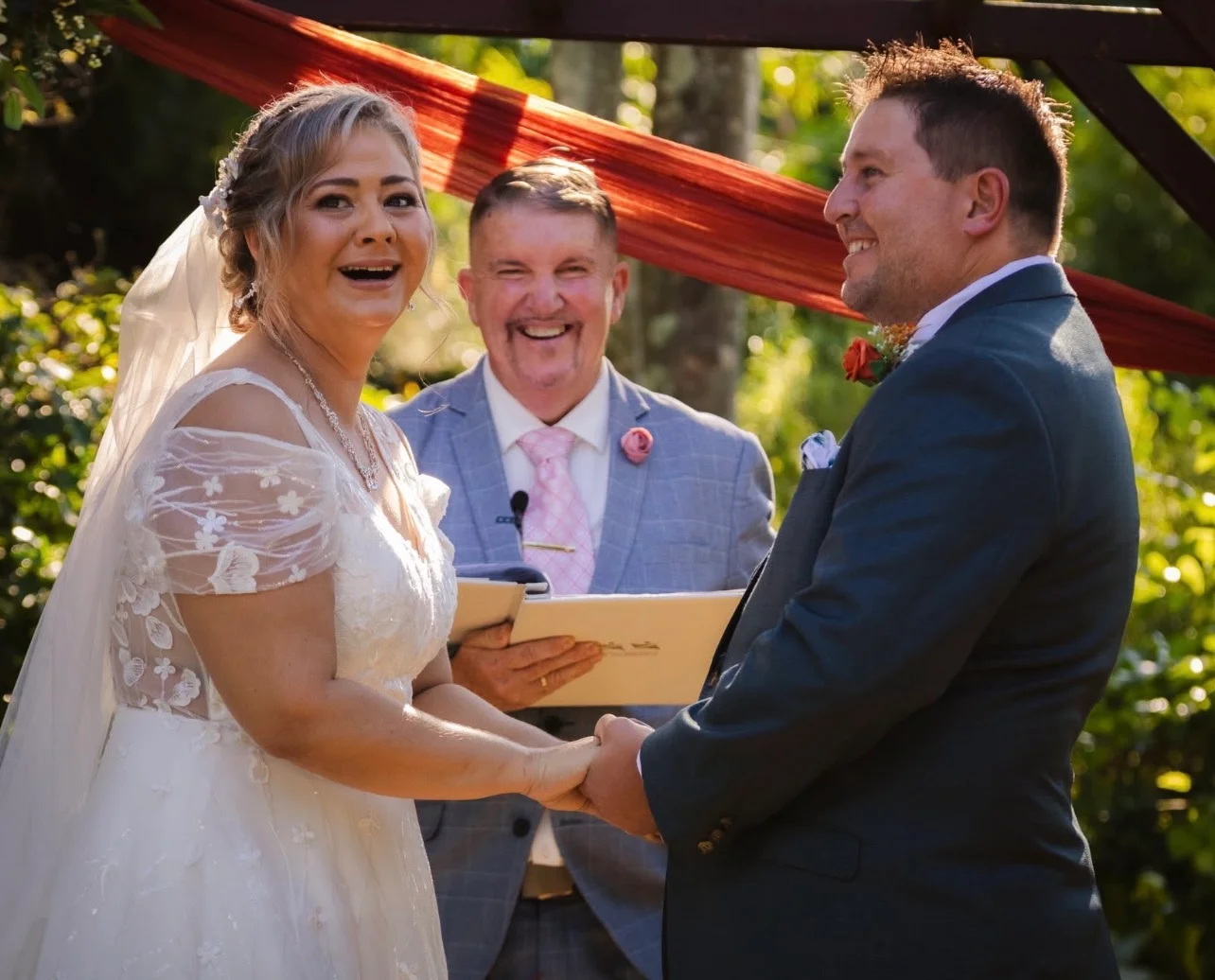 Mark smiling as a couple share a joyful moment during their ceremony